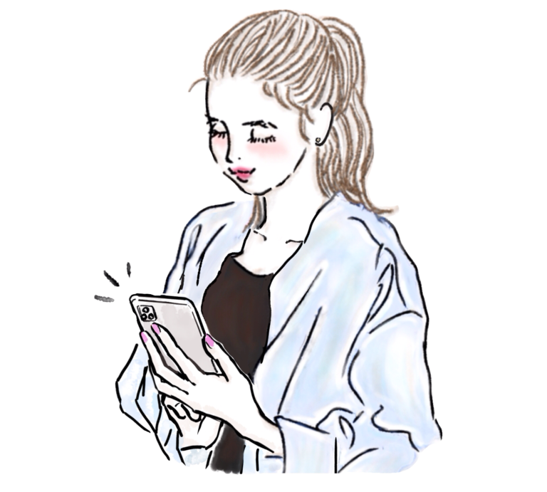 スマホを見てタッチするポニテおしゃれ女性